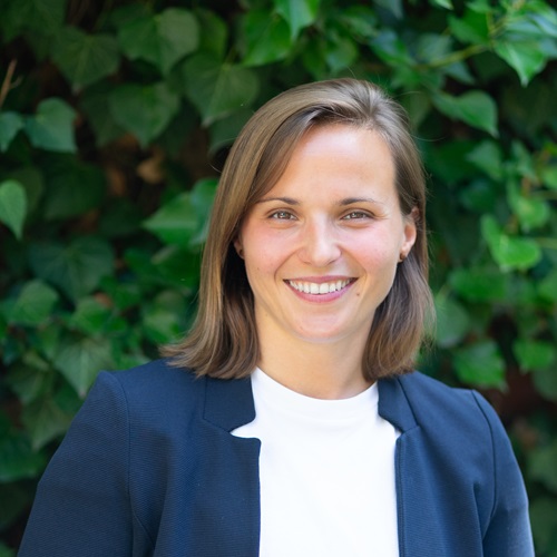 Porträt von Katharina Merkle vor einem grünen Hintergrund.